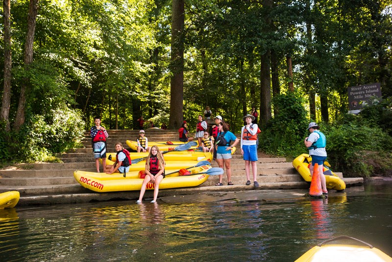 Kids prepare to kayak on the river