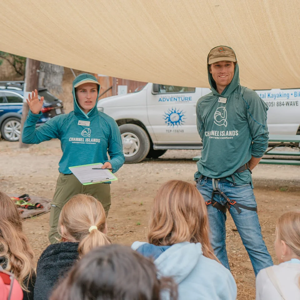 two outdoor rec guides presenting to a group of people