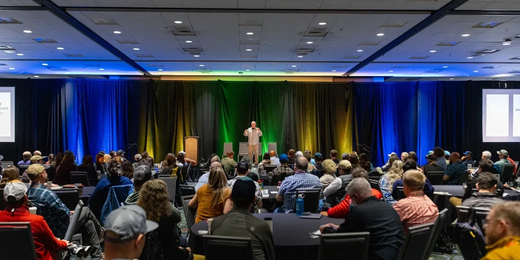 outdoor recreation professionals paying attention to a keynote speaker at the america outdoors conference
